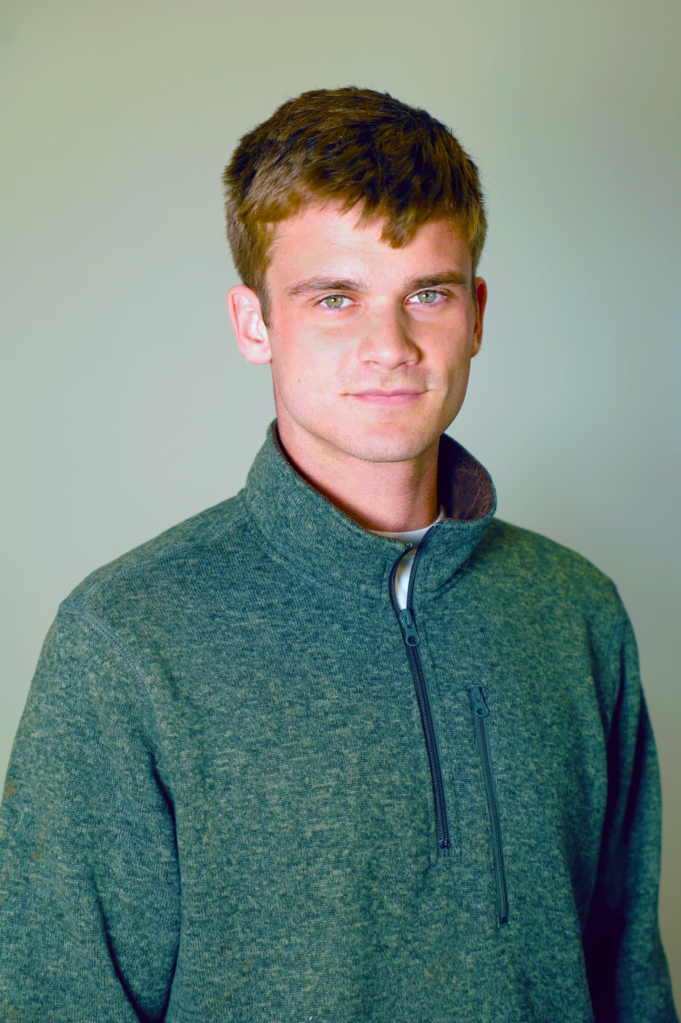 Drew Caywood in a green quarter-zip